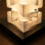 Alden Interlocking Alabaster Column Floor Lamp | Natural Alabaster and Metal | Macro detail shot of the dark square base and lower alabaster column | Severn Lighting