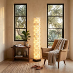 Alden Interlocking Alabaster Column Floor Lamp | Natural Alabaster and Metal | Lighting a cozy reading nook between two tall windows | Severn Lighting