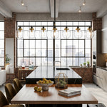 Alistair Linear Glass Globe Chandelier | Industrial Dining Light | Staged over a rustic wood kitchen island counter facing large industrial grid windows in a bright loft apartment | Severn Lighting