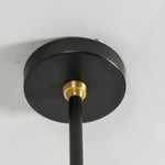 Alistair Linear Glass Globe Chandelier | Ceiling Canopy Detail | Close-up architectural view of the round matte black metal ceiling canopy with a contrasting brushed gold brass rod connector | Detail shot | Severn Lighting