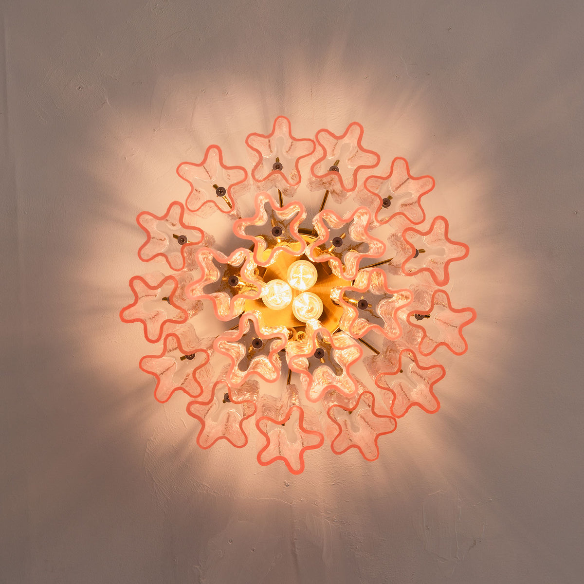Amabel Dazzling Pink Glass Ceiling Light | Pink Glass and Brass | Bottom-up perspective showing the starburst light pattern on the ceiling | Severn Lighting