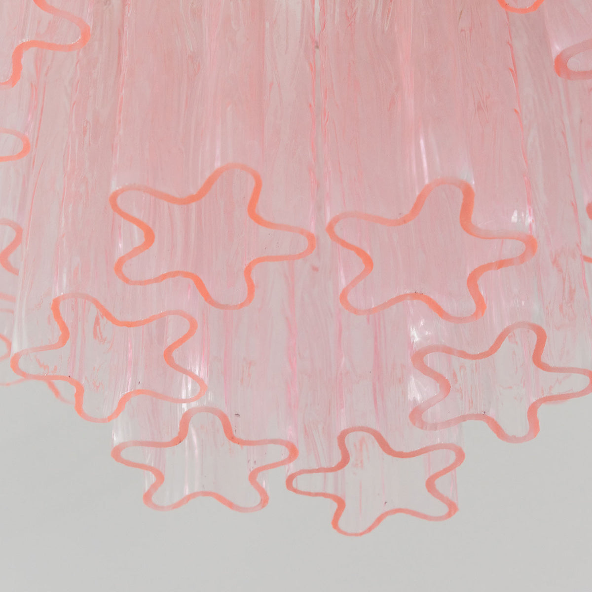 Amabel Dazzling Pink Glass Ceiling Light | Pink Glass and Brass | Detail shot highlighting the star-shaped profile of the pink glass tubes | Severn Lighting