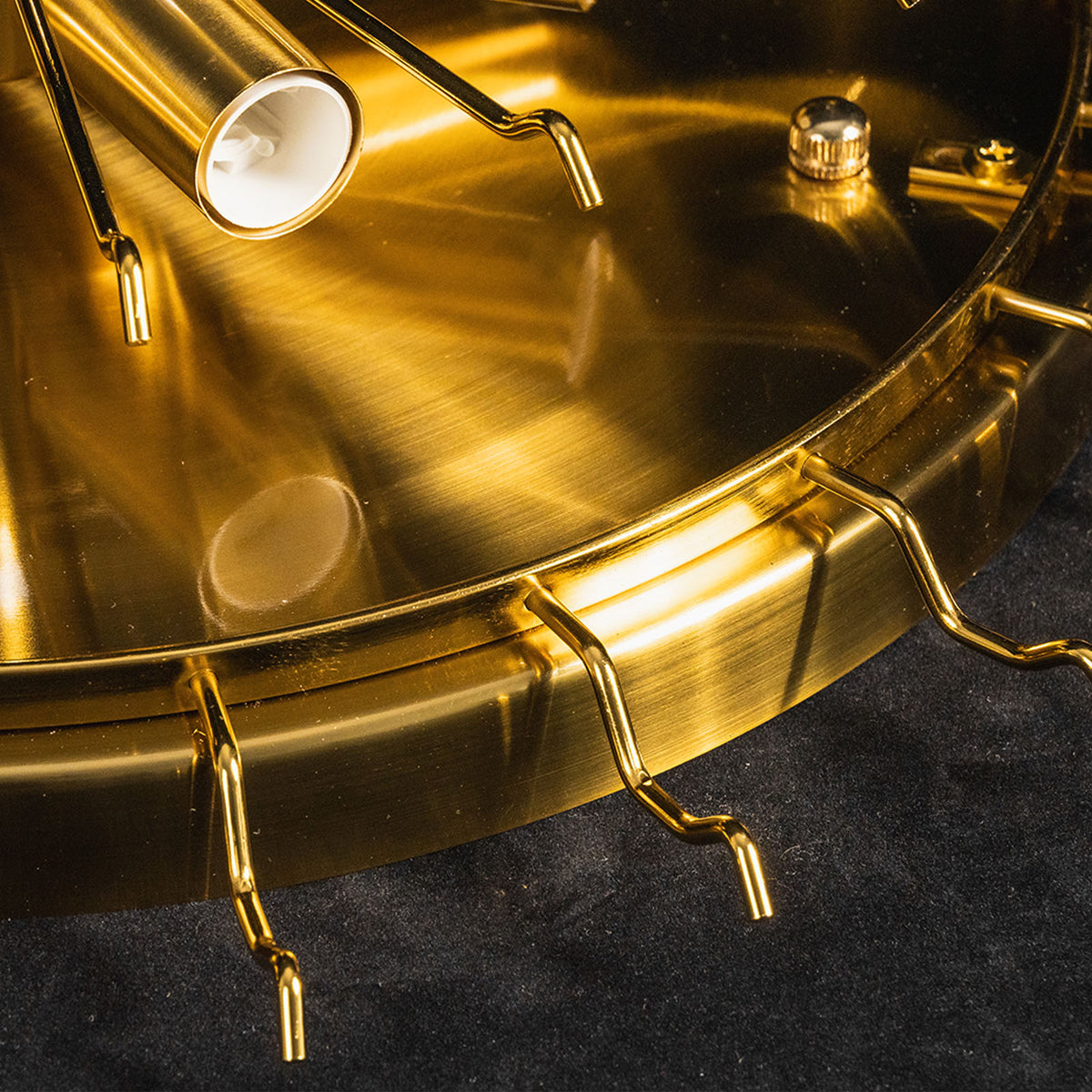 Ambleve Amber Glass Tube Flush Mount Chandelier | Fluted Amber Glass and Brass | Close-up detail of the brushed brass mounting ring with hanging hooks | Severn Lighting