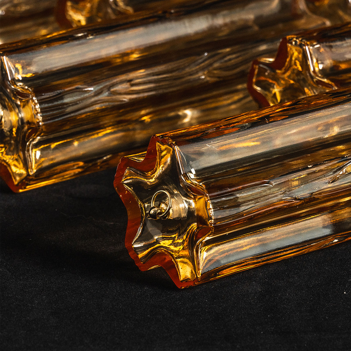Ambleve Amber Glass Tube Flush Mount Chandelier | Fluted Amber Glass and Brass | Close-up shot showing the star-shaped profile ends of amber glass tubes | Severn Lighting