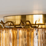 Ambleve Amber Glass Tube Flush Mount Chandelier | Fluted Amber Glass and Brass | Detail shot of top brass rim holding tiered amber glass tubes | Severn Lighting