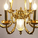 Anders Fluted Glass Urn Brass Chandelier | Fluted Glass and Brass | Medium close-up highlighting the illuminated candle bulbs and center urn | Severn Lighting