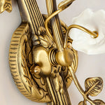 Armelle Rose Glass Brass Wall Lamp | Glass, Ceramic and Brass | Close-up detail of the carved ribbon bow brass backplate | Severn Lighting