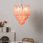 Aubine Pink Textured Glass Tiered Chandelier | Pink Textured Glass and Brass | Real-life view hanging above a round dining table near a white fireplace | Severn Lighting