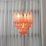 Aubine Pink Textured Glass Tiered Chandelier | Pink Textured Glass and Brass | Real-life view glowing softly against sheer white window drapes | Severn Lighting