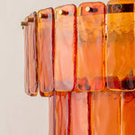 Aurelia Tiered Amber Glass Chandelier | Glass, Metal | Close-up side profile highlighting the smooth rounded edges and vibrant glossy translucent texture of the amber orange glass slats | Detail shot | Severn Lighting
