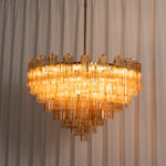 Auriane Fluted Amber Glass Chandelier | Fluted Amber Glass and Brass | Illuminated ambiance shot showing tiered amber glass warmth | Severn Lighting