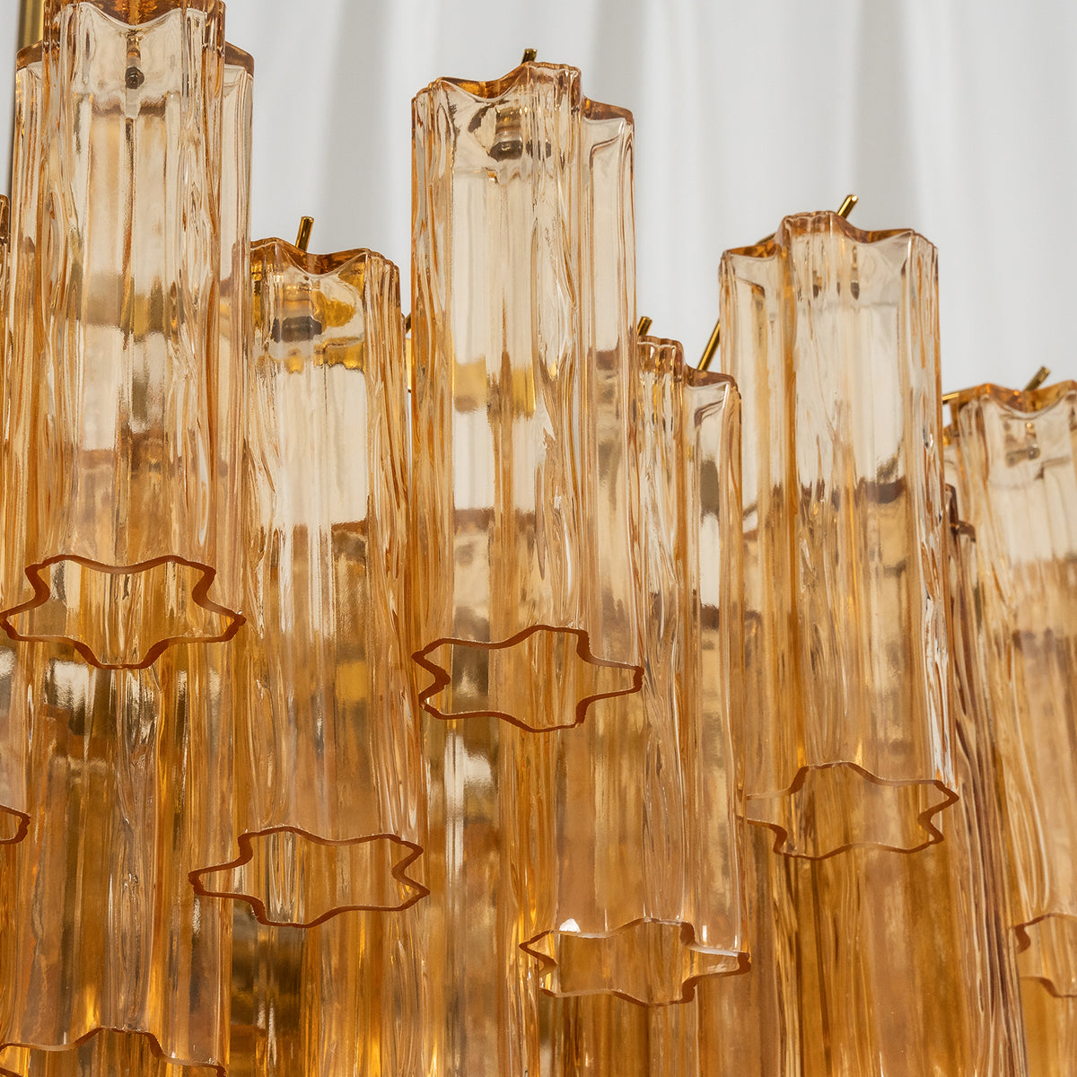 Auriane Fluted Amber Glass Chandelier | Fluted Amber Glass and Brass | Detail shot of the vertical fluted amber glass shade elements | Severn Lighting
