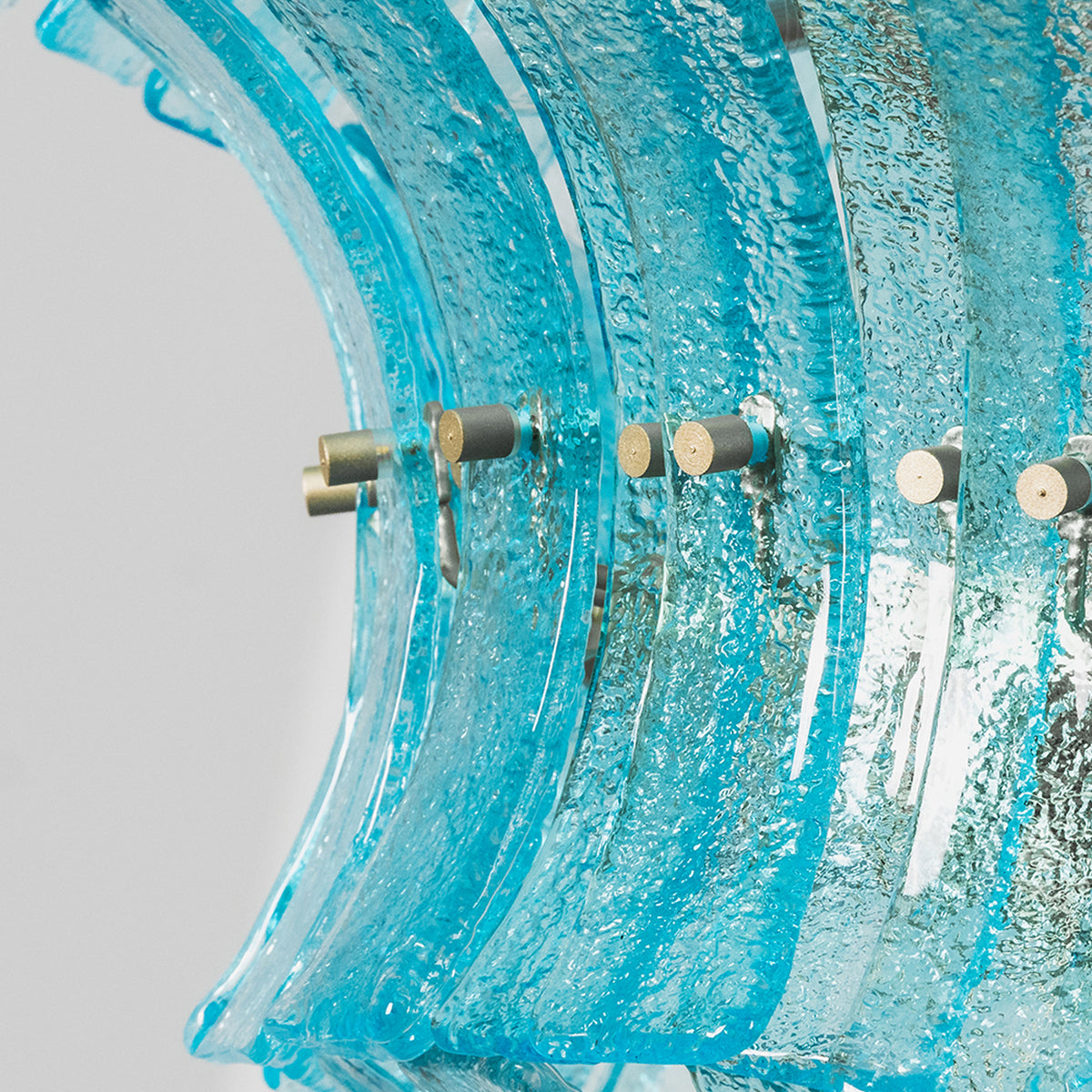 Azura Aquamarine Cascading Glass Chandelier | Glass, Metal | Close-up side profile highlighting the wave-like rippled edges of the blue glass tiles and the gold frame attachments | Detail shot | Severn Lighting