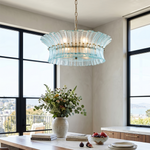 Azura Aquamarine Cascading Glass Chandelier | Glass, Metal | Suspended gracefully above a long wooden dining table set with modern chairs in a spacious room with floor-to-ceiling windows | Severn Lighting
