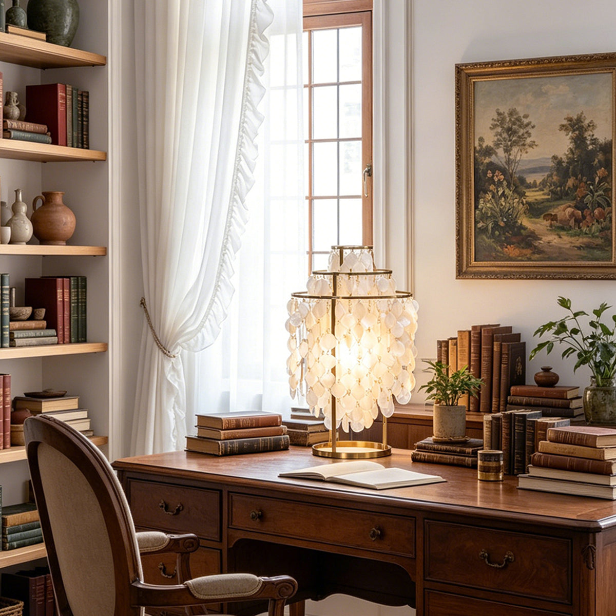 Callista Tiered Capiz Table Lamp | Capiz, Metal | Positioned as an elegant statement desk light on a traditional dark wood executive writing desk in a sunlit home office | Severn Lighting