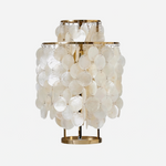 Callista Tiered Capiz Table Lamp | Capiz, Metal | Isolated unlit view of a coastal chic tiered table lamp featuring multiple concentric layers of round translucent white capiz shell discs on a circular gold brass base | White background | Severn Lighting