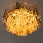 Cassian Tiered Fluted Glass Ceiling Light | Tiered Fluted Glass and Gold Brass | Low-angle studio perspective shot fully lit with warm golden light emphasizing the tiered layers | Severn Lighting