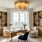 Cassian Tiered Fluted Glass Ceiling Light | Tiered Fluted Glass and Gold Brass | Illuminating a bright home office library room above a wooden desk flanked by tall bookshelves | Severn Lighting