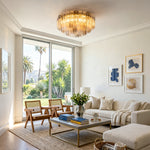Cassian Tiered Fluted Glass Ceiling Light | Tiered Fluted Glass and Gold Brass | Casting a warm glow in a spacious contemporary living room with a cream fabric sofa and sliding doors | Severn Lighting