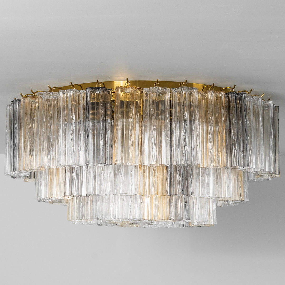 Cassian Tiered Fluted Glass Ceiling Light | Tiered Fluted Glass and Gold Brass | Standard studio profile view hanging unlit against a clean light grey minimalist background | Severn Lighting