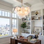 Celestia Art Glass Disc Chandelier | Glass, Metal | Hanging as a luxury statement lighting piece in a bright home office with a dark wood desk and bookshelves near a city-view window | Severn Lighting