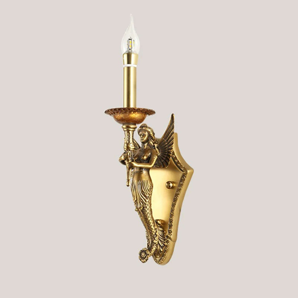 Clemency Winged Figure Brass Sconce | Cast Brass and Glass | Full illuminated view displayed against a light neutral background | Severn Lighting