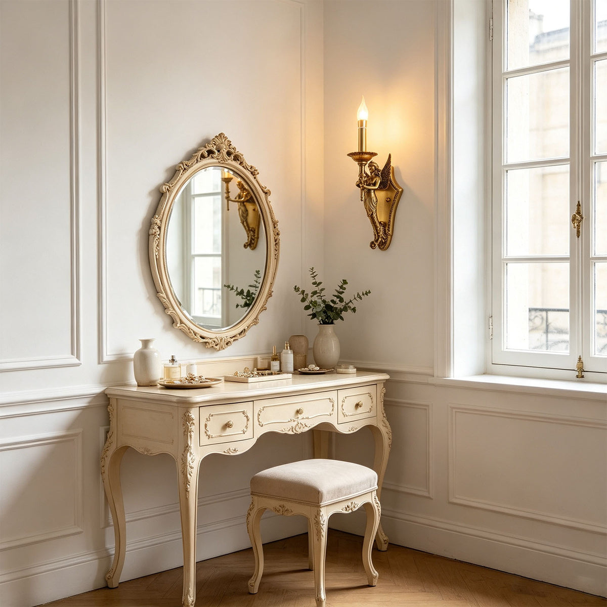 Clemency Winged Figure Brass Sconce | Cast Brass and Glass | Enhancing a vanity dressing room beside an ornate oval mirror | Severn Lighting