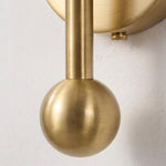 Cordelia Alabaster Globe Wall Sconce | Natural Alabaster and Brushed Brass | Extreme macro close-up focusing on the polished gold sphere finial at the bottom of the stem | Severn Lighting