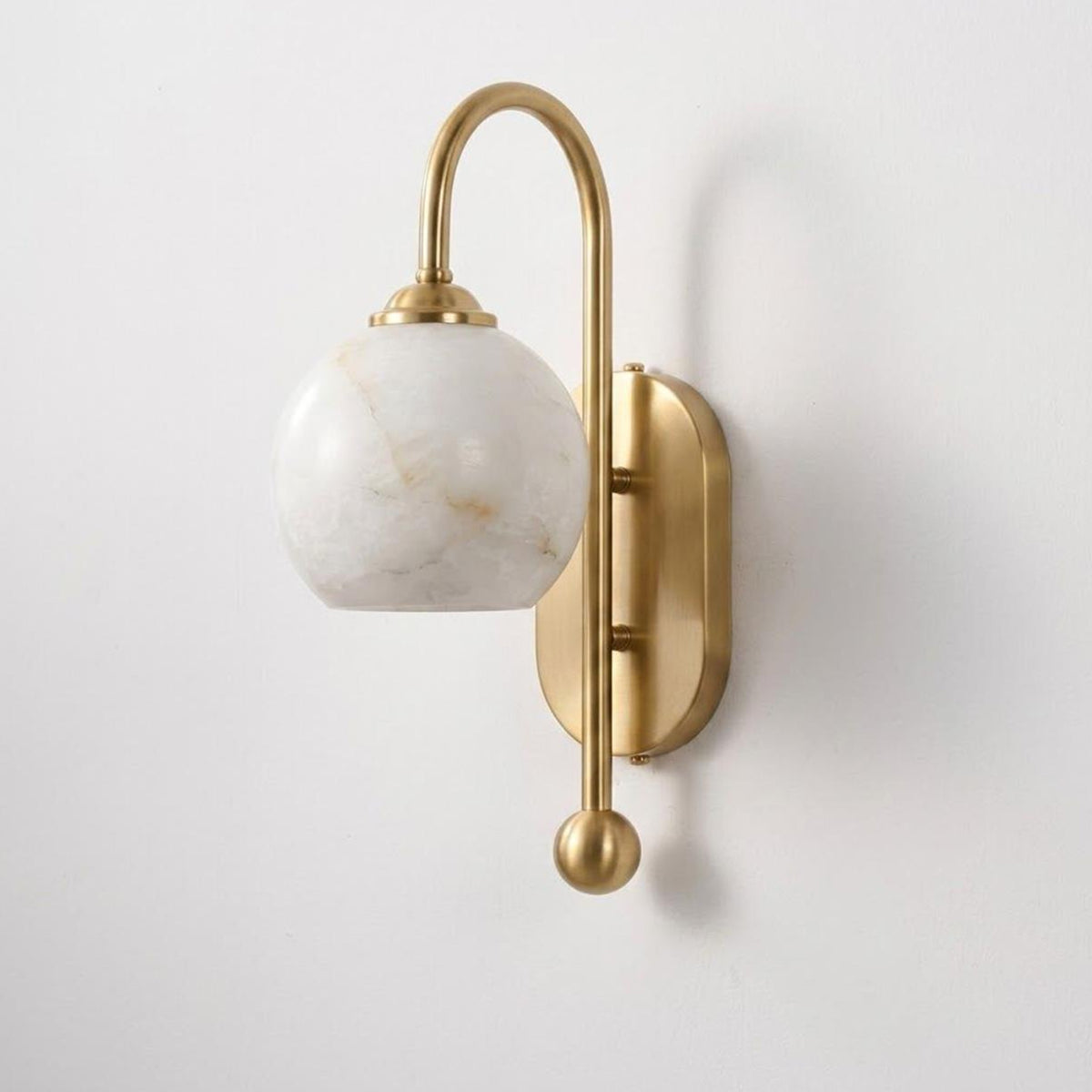 Cordelia Alabaster Globe Wall Sconce | Natural Alabaster and Brushed Brass | Angled studio product presentation hanging against a clean light neutral background | Severn Lighting