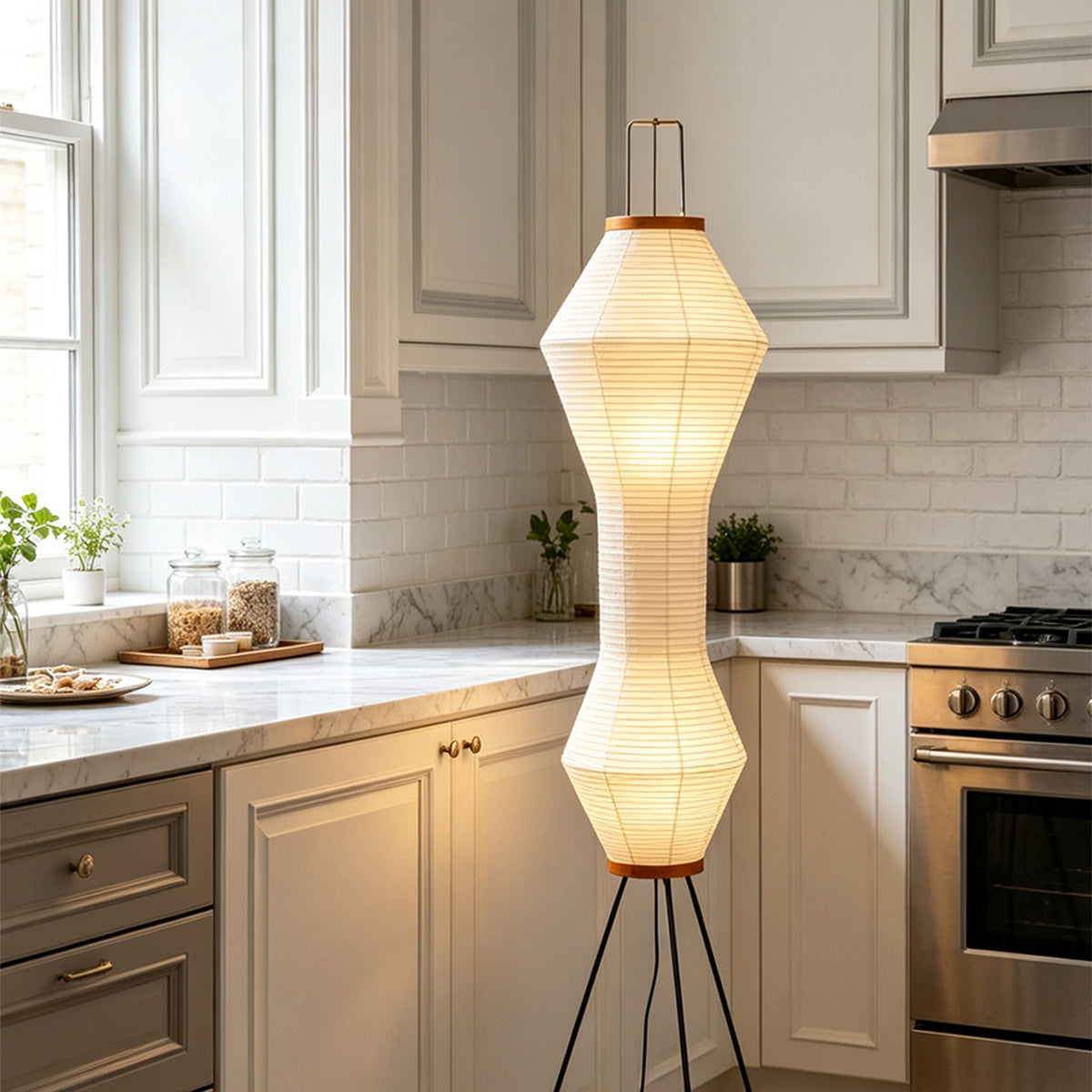 Cosima Hourglass Washi Paper Floor Lamp | Japanese Wabi-Sabi Paper and Black Tripod | Placed near white shaker kitchen cabinets adding warm sculpted lighting to the room | Severn Lighting