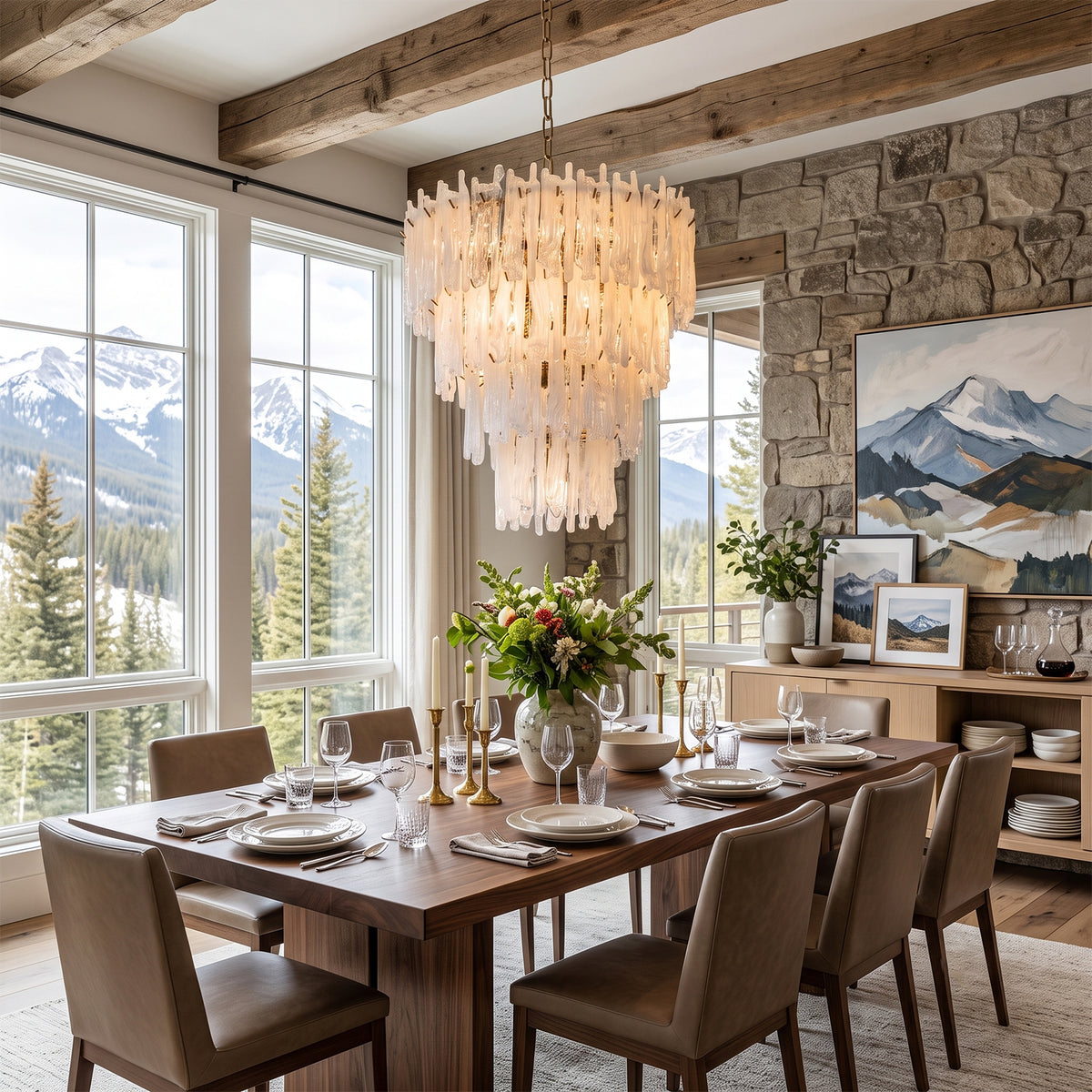 Ethereal Icicle Waterfall Chandelier | Frosted Icicle Glass and Gold Brass | Positioned in a mountain view chalet dining room above a long wooden table with upholstered chairs | Severn Lighting