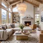 Ethereal Icicle Waterfall Chandelier | Frosted Icicle Glass and Gold Brass | Hanging in a cozy rustic chalet living room with a high wood ceiling and a stone fireplace | Severn Lighting