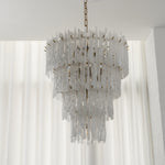Ethereal Icicle Waterfall Chandelier | Frosted Icicle Glass and Gold Brass | Unlit standard product display hanging against white sheer backdrop curtains | Severn Lighting