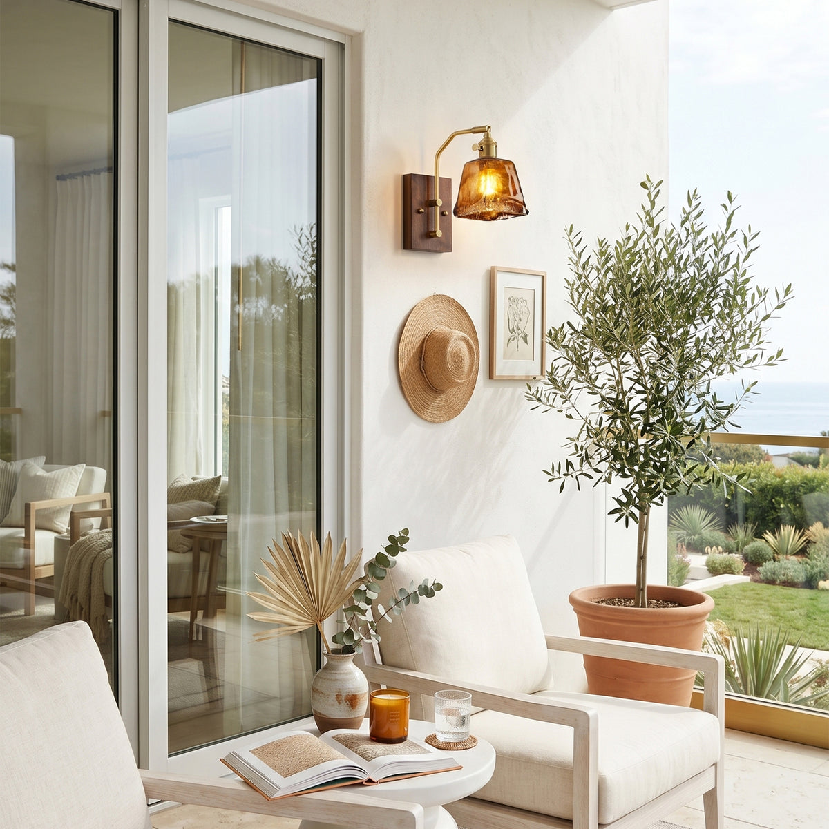 Everett Amber Ripple Wall Sconce | Amber Rippled Glass and Walnut Wood | Mounted on a balcony wall next to a glass door and an olive tree potted plant | Severn Lighting