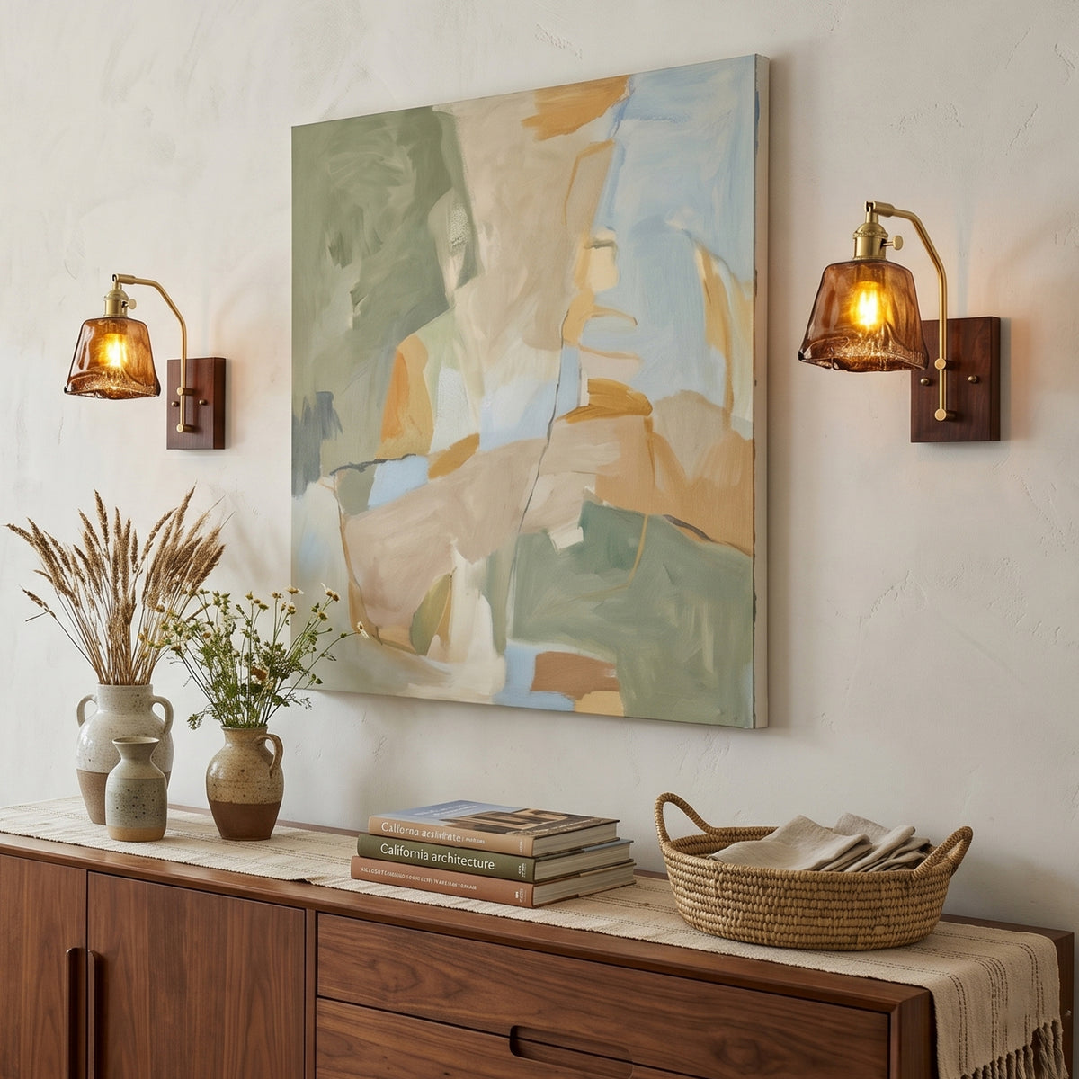 Everett Amber Ripple Wall Sconce | Amber Rippled Glass and Walnut Wood | A pair of wall lamps flanking a large abstract painting above a wooden sideboard | Severn Lighting