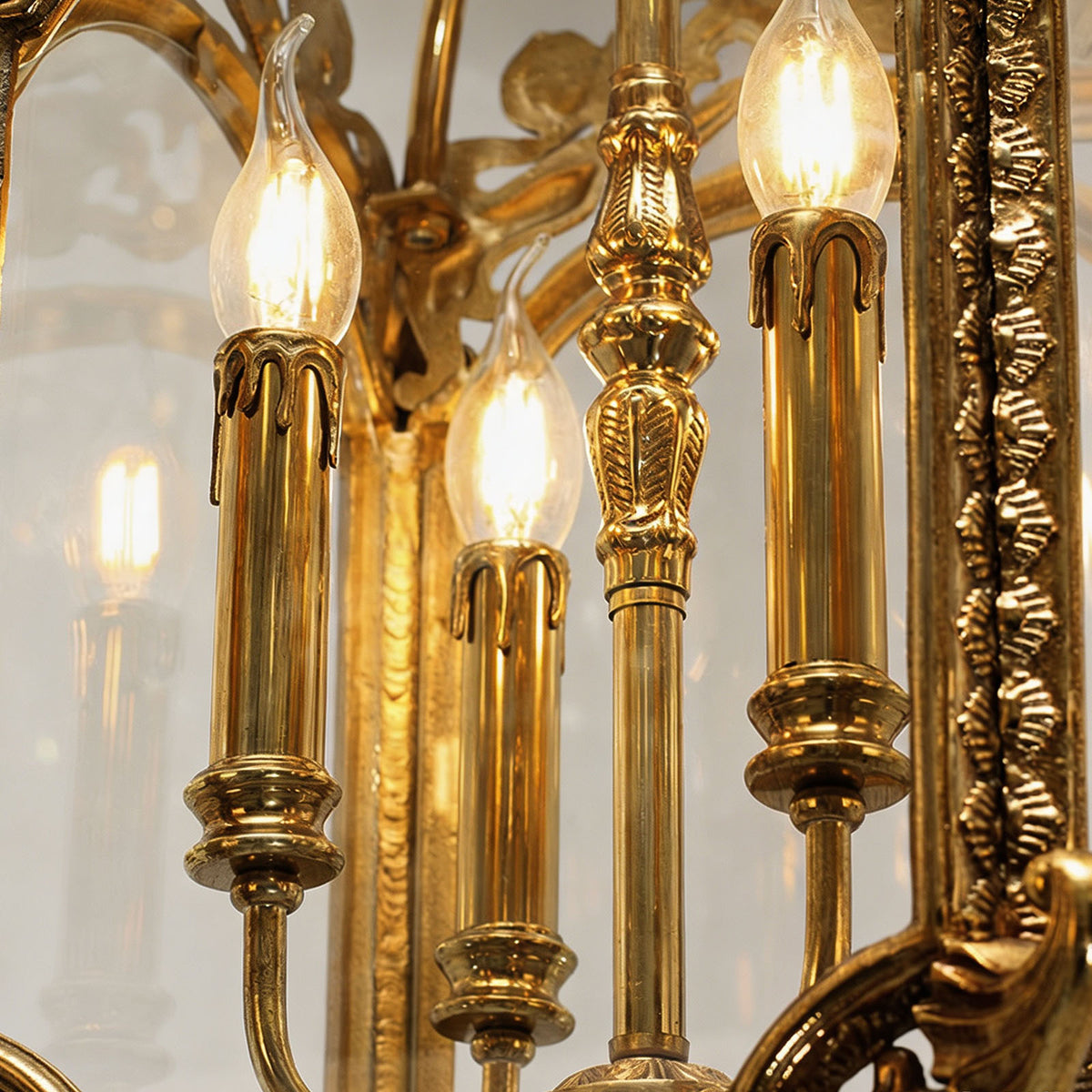 Florian Fretwork Brass Lantern Pendant Light | Glass and Brass | Detail shot highlighting the illuminated candle bulbs inside the lantern | Severn Lighting
