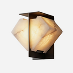 Freya Angular Alabaster Wall Sconce | Alabaster, Metal | Isolated lit view of an architectural geometric wall sconce featuring angular folded natural white alabaster stone shades on a dark bronze backing plate | White background | Severn Lighting