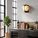 Freya Angular Alabaster Wall Sconce | Industrial Kitchen Bar | Mounted on a concrete texture wall next to a modern dark kitchen island counter, wine cooler, and grid window | Severn Lighting