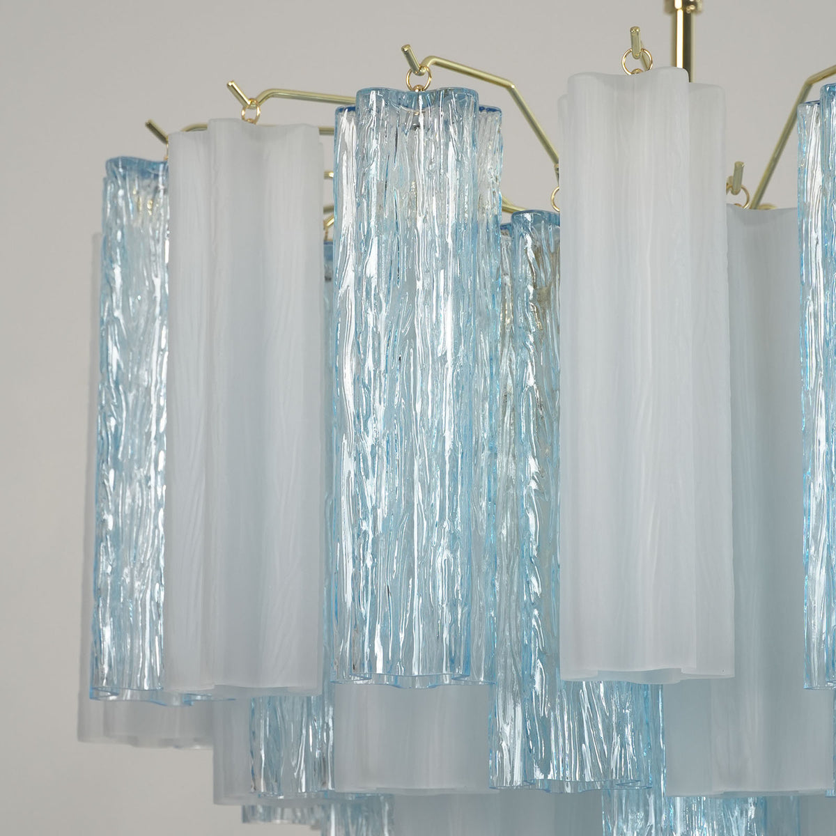Givrane Two-Tone Glass Tube Tiered Chandelier | Two-Tone Glass and Brass | Detail shot showing the beautiful contrast of blue and white glass tubes | Severn Lighting