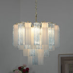 Givrane Two-Tone Glass Tube Tiered Chandelier | Two-Tone Glass and Brass | Real-life illuminated view glowing softly against a dark grey background | Severn Lighting
