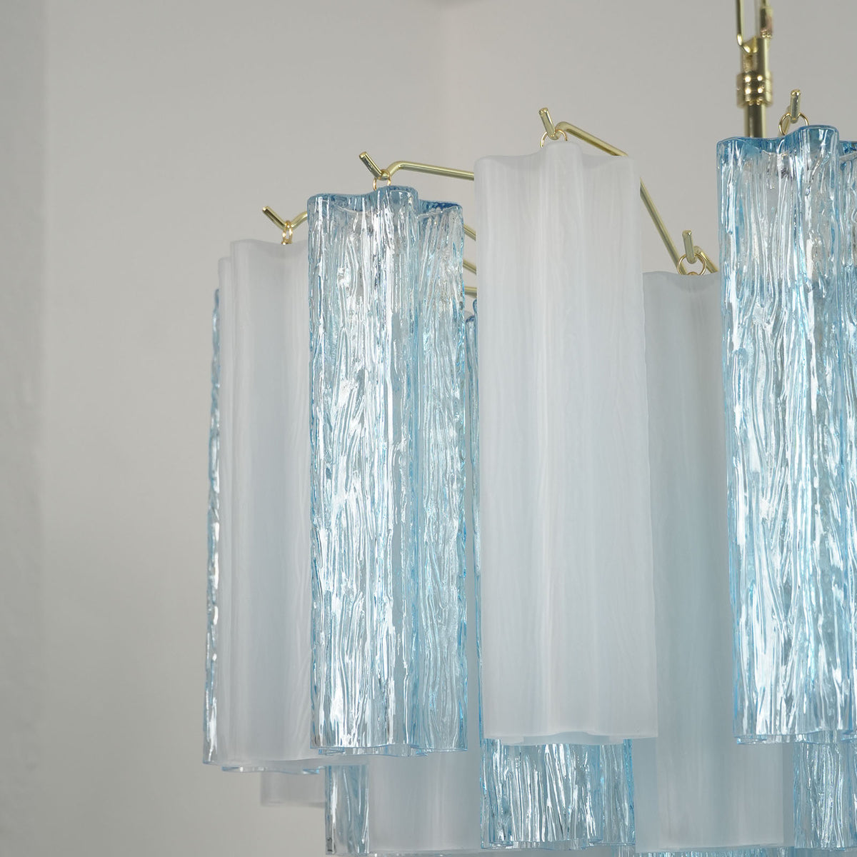 Givrane Two-Tone Glass Tube Tiered Chandelier | Two-Tone Glass and Brass | Side close-up view highlighting the tiered two-tone glass tubes | Severn Lighting