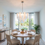 Givrane Two-Tone Glass Tube Tiered Chandelier | Two-Tone Glass and Brass | Positioned above a round dining table with four chairs in a bright room | Severn Lighting