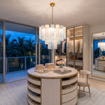 Givrane Two-Tone Glass Tube Tiered Chandelier | Two-Tone Glass and Brass | Suspended in a luxury walk-in closet with a circular island at dusk | Severn Lighting