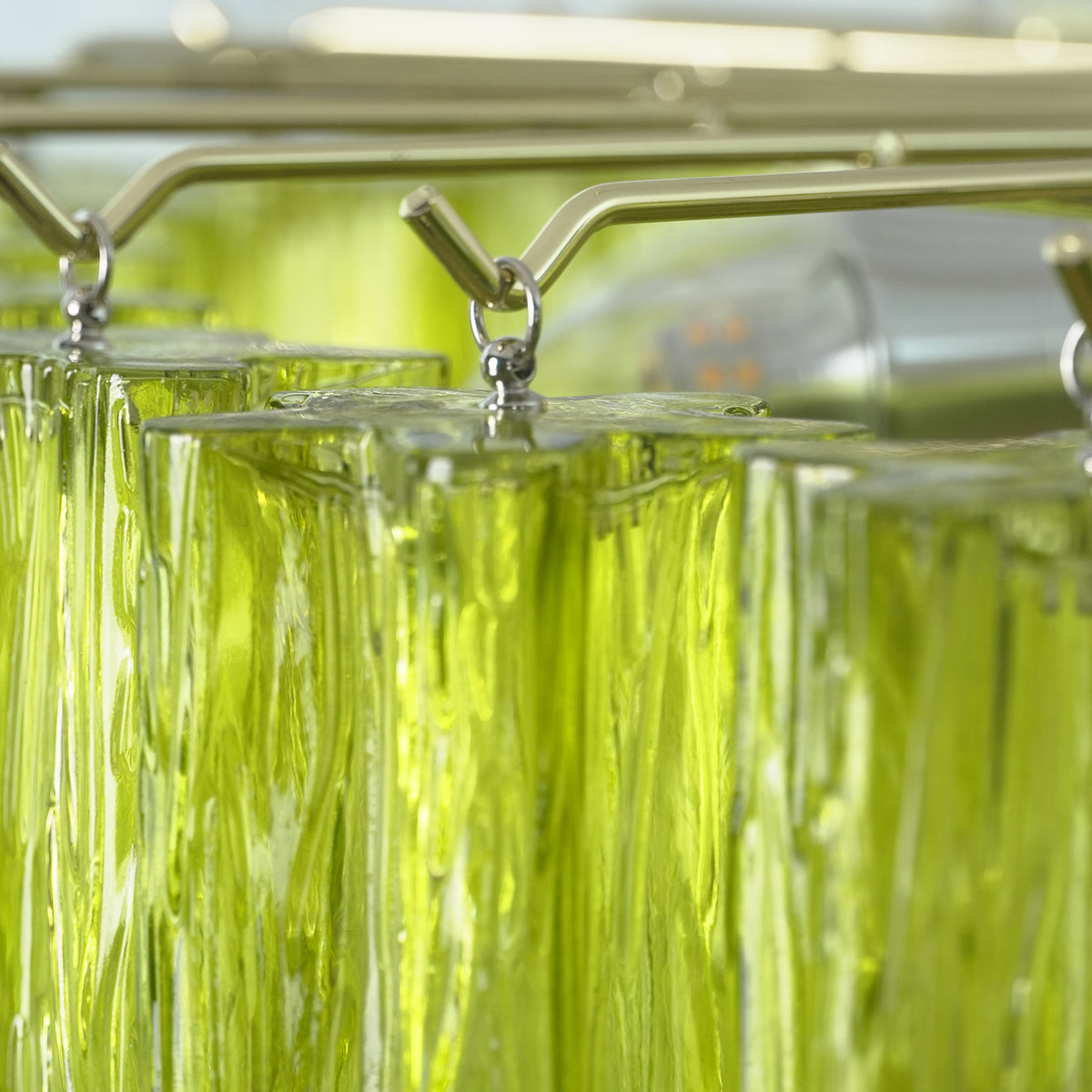 Green Glacier Tier Chandelier | Textured Green Glass | Detailed view of the internal metal frame and individual glass slats hanging from hardware hooks | Severn Lighting