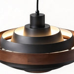 Holmvik Walnut Ring Tiered Metal Pendant Light | Walnut Wood and Metal | Top-down angled detail showing glowing black tiered metal rings and wood band | Severn Lighting