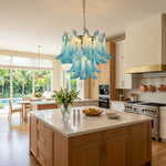 Isar Blue Petal Glass Chandelier | Blue Glass and Brass | Styled over a marble kitchen island counter with wooden cabinetry | Severn Lighting