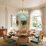 Isar Blue Petal Glass Chandelier | Blue Glass and Brass | Centered over a round dining table in a luxury dining room with arched windows | Severn Lighting