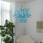 Isar Blue Petal Glass Chandelier | Blue Glass and Brass | Displayed in a room corner beside a tall green indoor houseplant | Severn Lighting