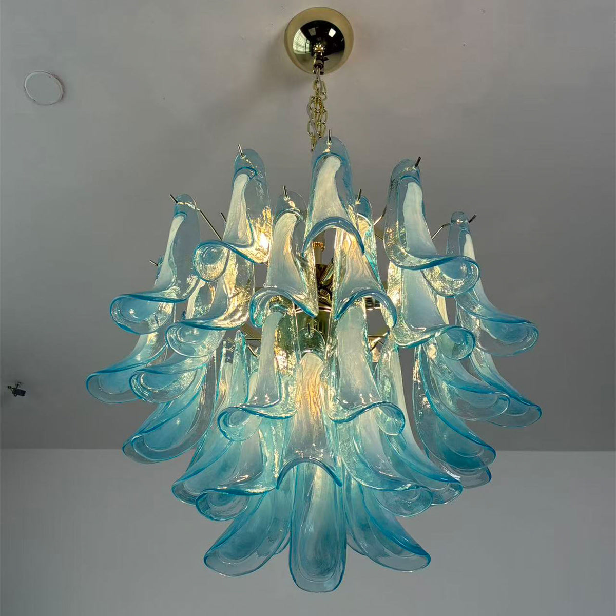 Isar Blue Petal Glass Chandelier | Blue Glass and Brass | Bottom-up angled view of the blue petal glass chandelier on a ceiling | Severn Lighting