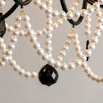 Isolde Pearl Swag Candle Chandelier | Pearl Beads, Crystal and Metal | Close-up detail showing layered white pearl bead chains and black crystal drop | Severn Lighting